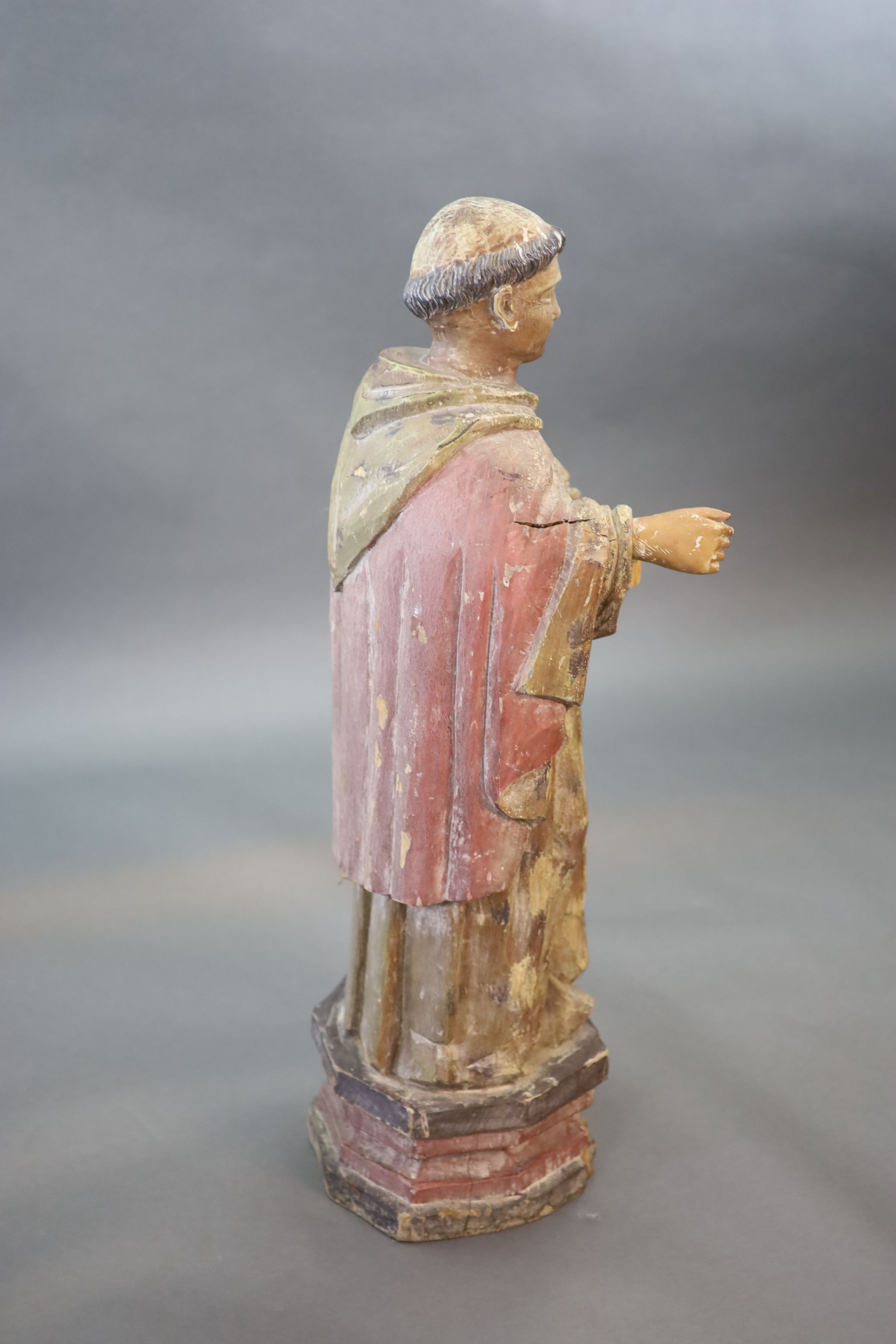 A large carved hardwood study of a standing monk or Saint, early 20th century 102cm high